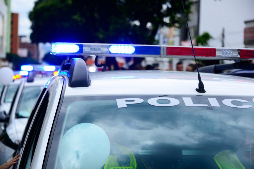 A close-up of a police car with a blue flashing light